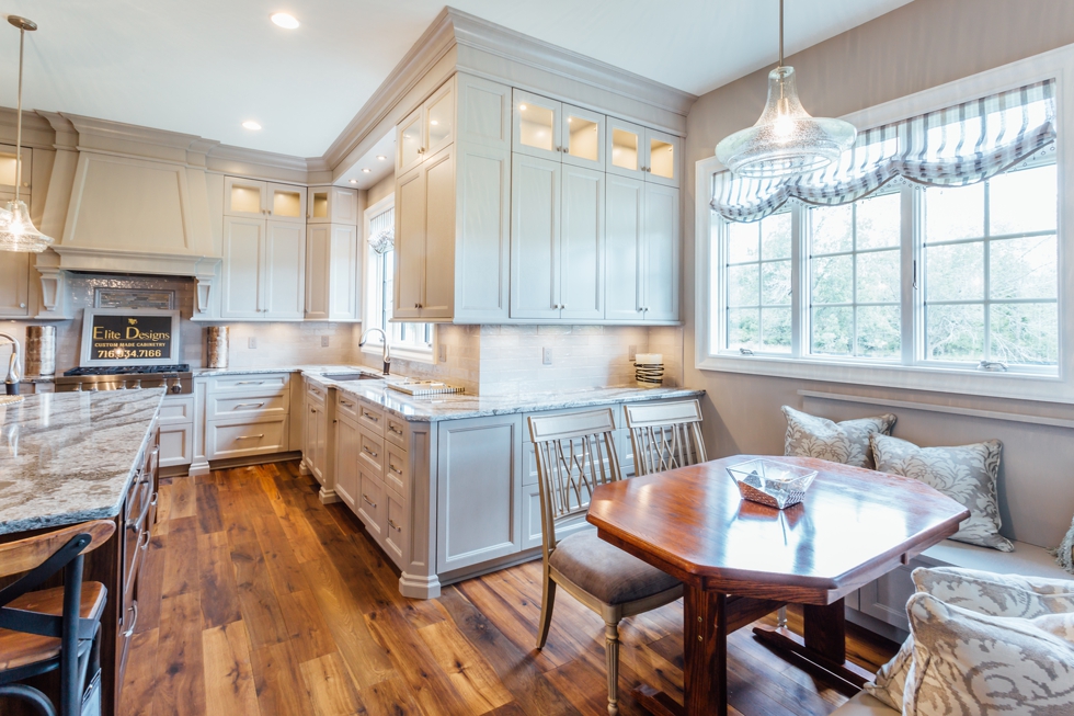 Taupe Custom Kitchen with Wood Island & Pantry - Family owned western new york custom cabinetry serving williamsville, amherst, clarence, and east aurora. #benjaminmoore #plymouthrock #recessedcabinetry #undercabinetlighting #jenn-air #woodisland #cambriacountertops #breakfastbanquet #homeshow