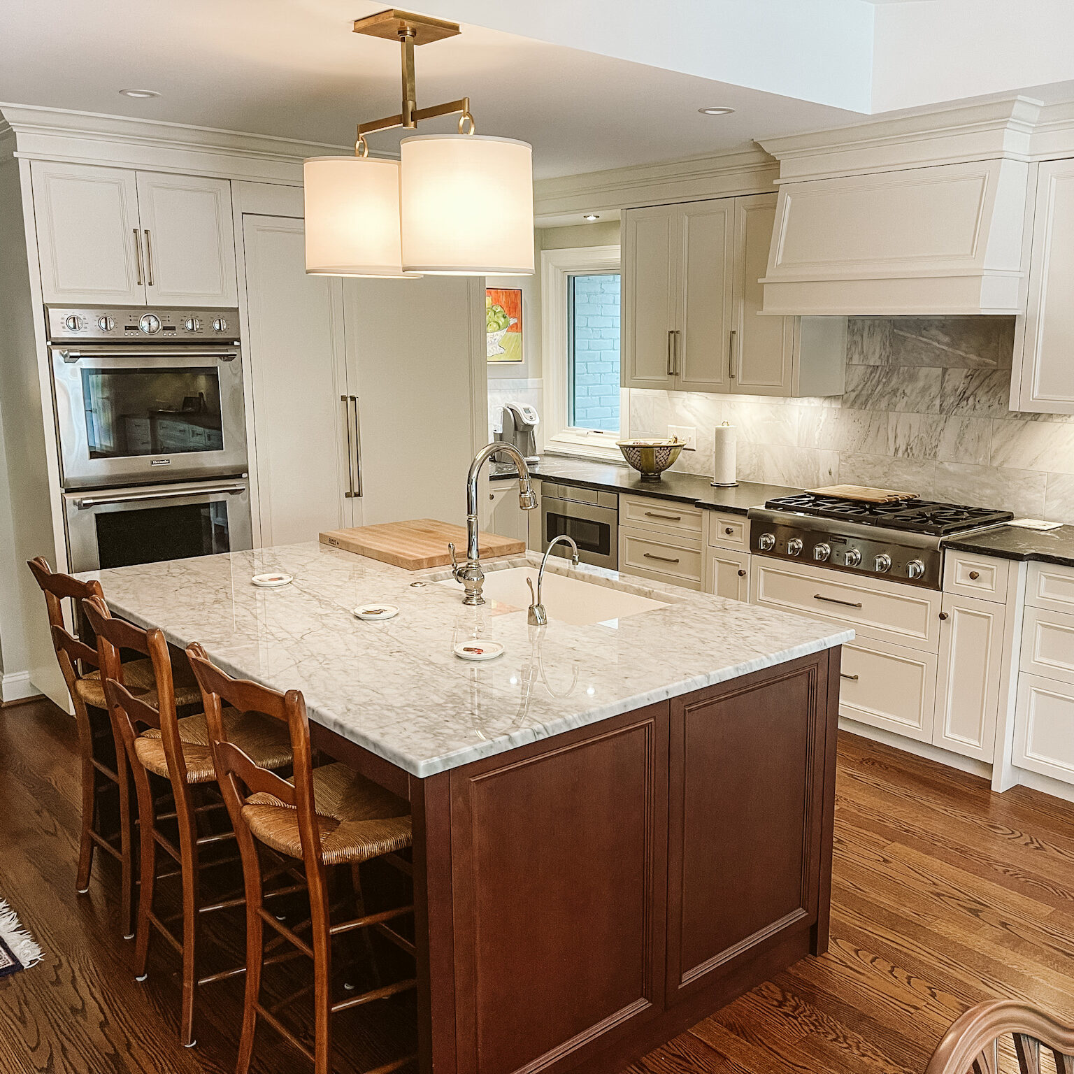 wood island with painted white cabinetry, custom kitchen